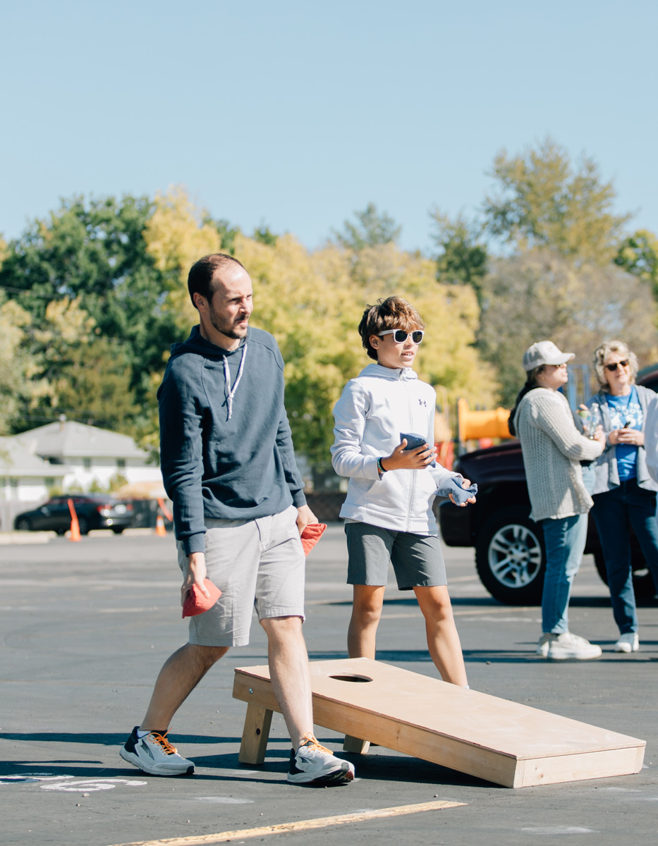 father and son having fun playing outdoor games at church event