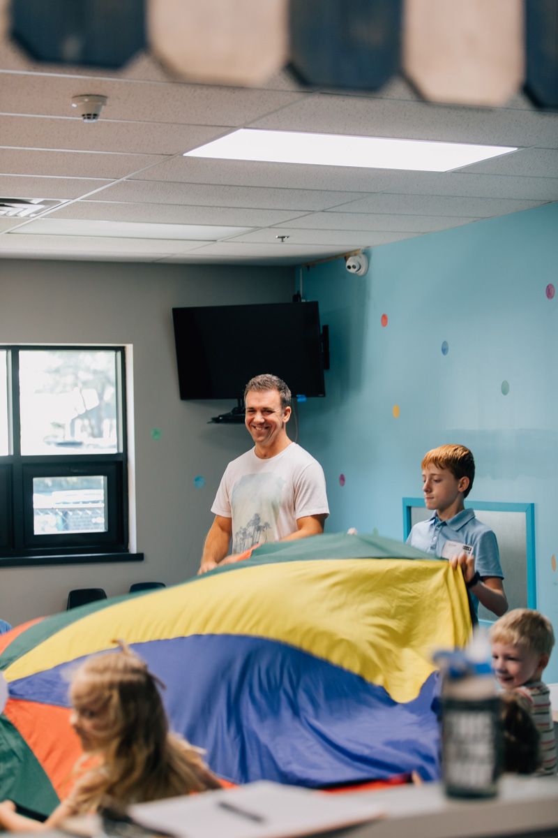 class teacher helping disciple kids