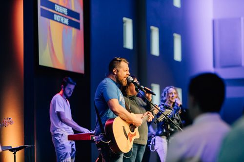 worship leader playing music at sunday church service