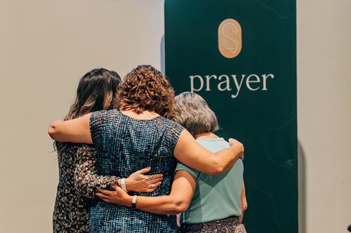 group of women praying at sunday church service