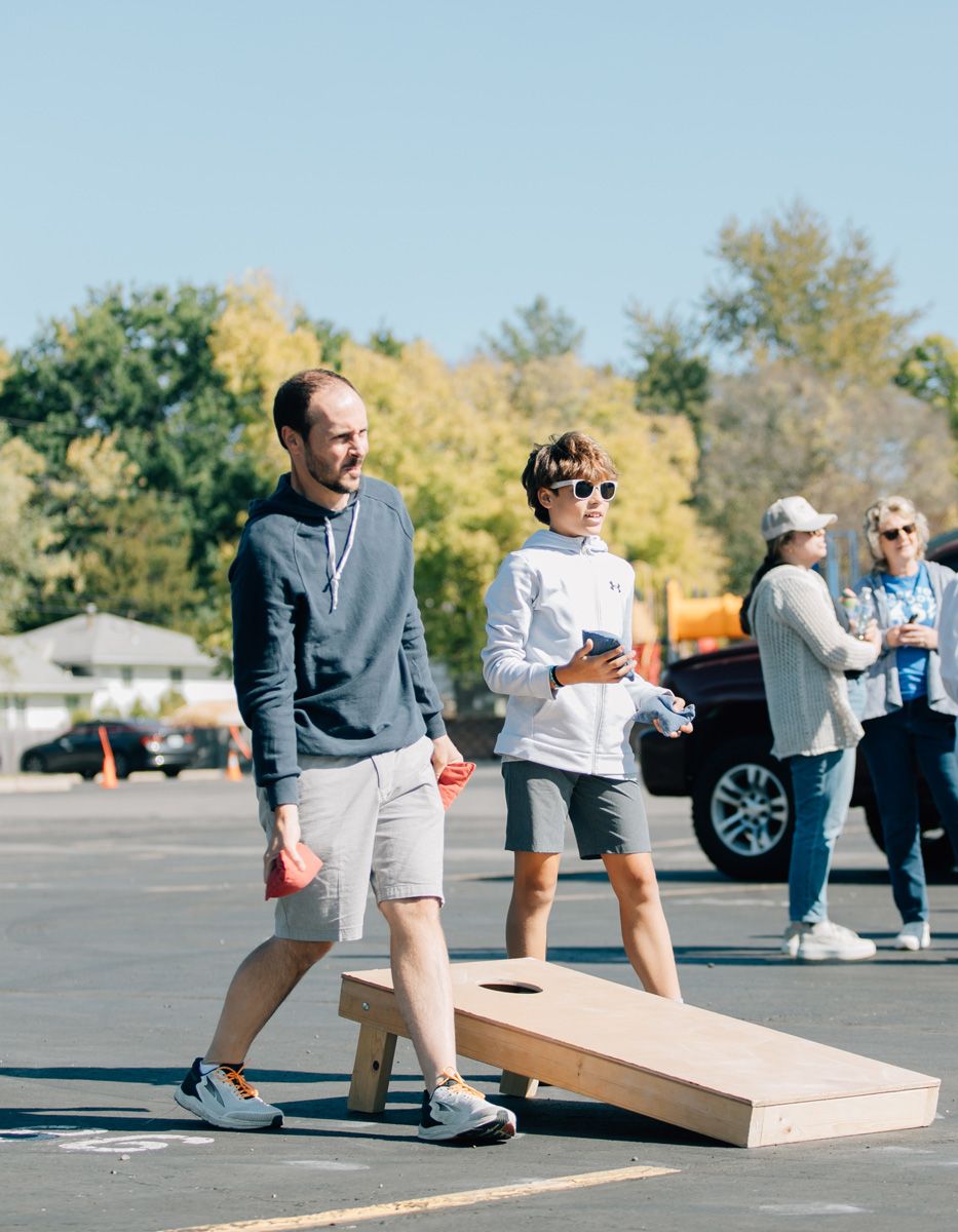 father and son having fun playing outdoor games at church event