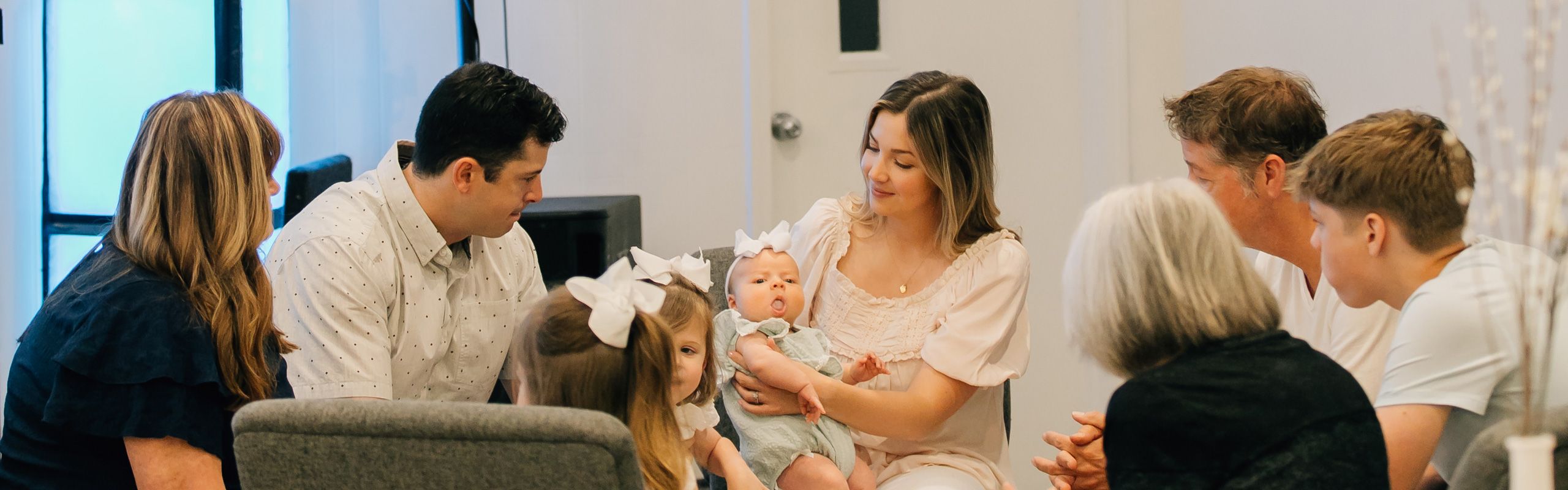 family preparing for a child dedication after church service