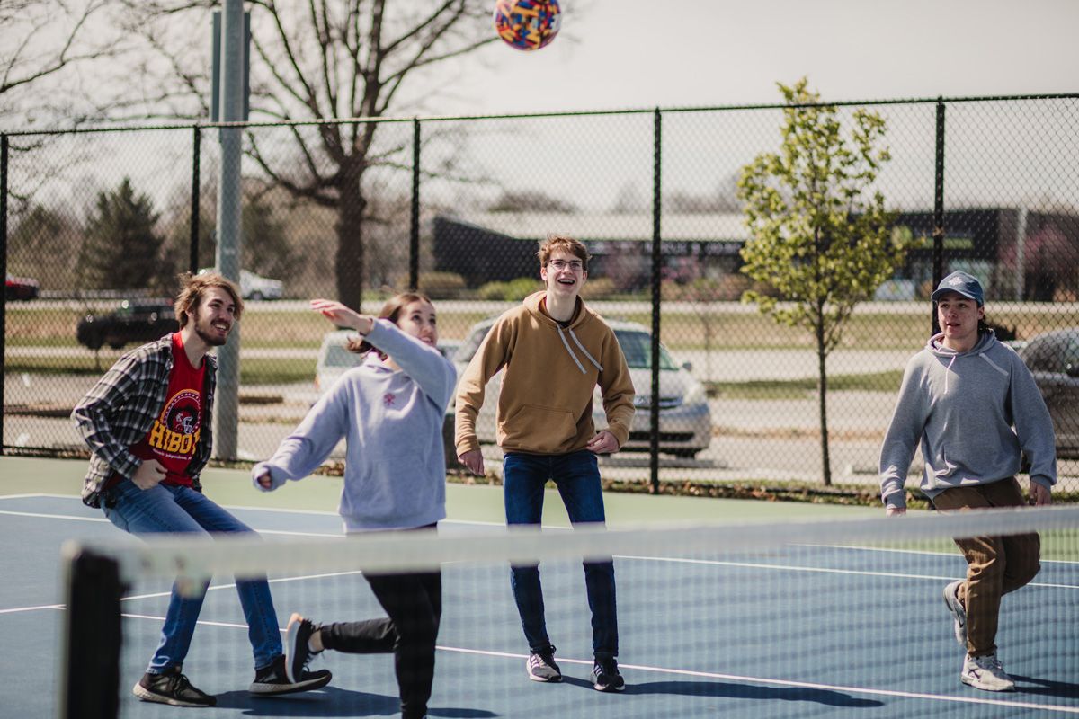 student youth group playing volleyball