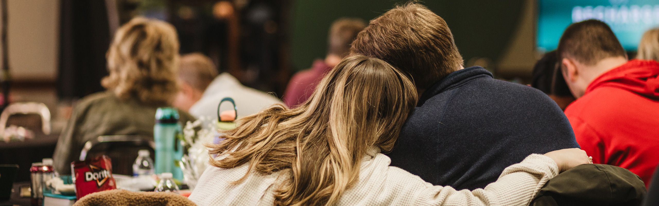 married couple embracing at marriage retreat