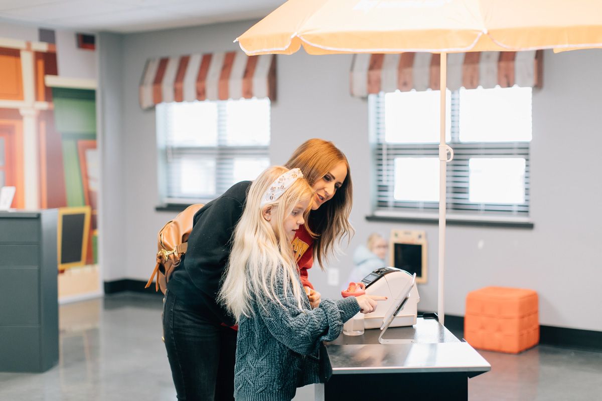 mother checking daughter into sunday school