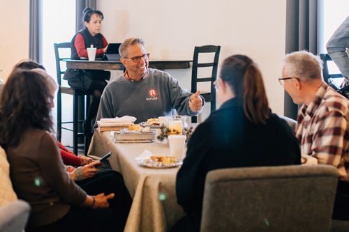 small group talking while enjoying a meal