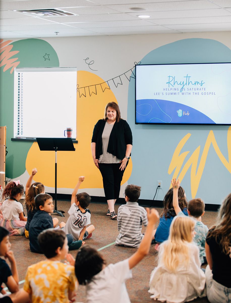sunday school teacher talking with children about God